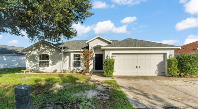3917 NW Warbler Dr, Winter Haven, FL 33880 - ranch-style house with stucco siding, concrete driveway, a garage, a shingled roof, and a front yard