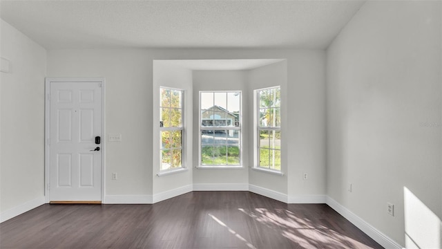 3917 NW Warbler Dr, Winter Haven, FL 33880 - spare room with dark wood finished floors and baseboards