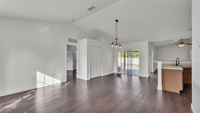 3917 NW Warbler Dr, Winter Haven, FL 33880 - unfurnished living room with vaulted ceiling, ceiling fan, dark wood-style floors, and a chandelier