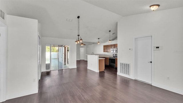 3917 NW Warbler Dr, Winter Haven, FL 33880 - unfurnished living room featuring lofted ceiling, dark wood-type flooring, and a chandelier