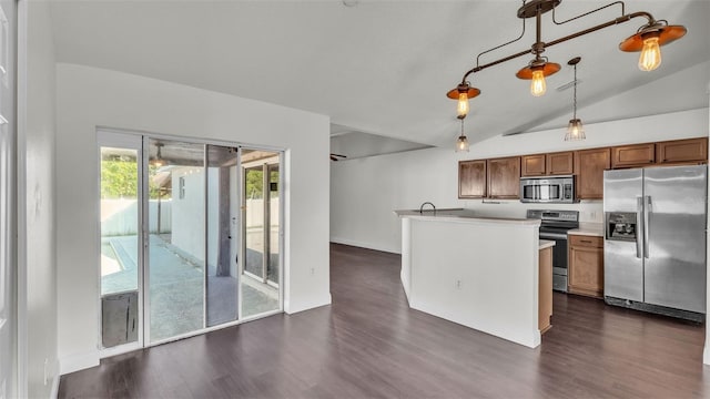 3917 NW Warbler Dr, Winter Haven, FL 33880 - kitchen featuring stainless steel appliances, dark wood-type flooring, lofted ceiling, decorative light fixtures, and brown cabinets