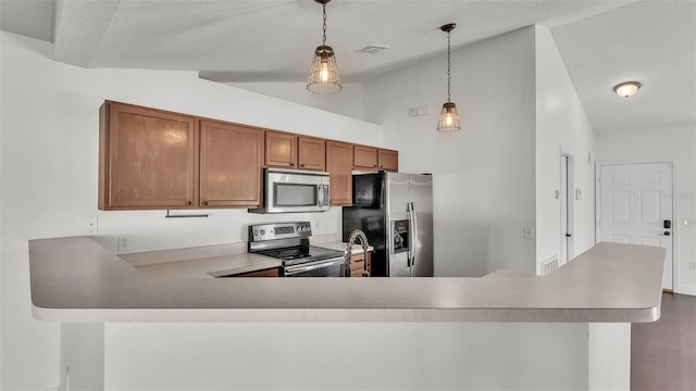 3917 NW Warbler Dr, Winter Haven, FL 33880 - kitchen featuring stainless steel appliances, brown cabinetry, a peninsula, pendant lighting, and light countertops