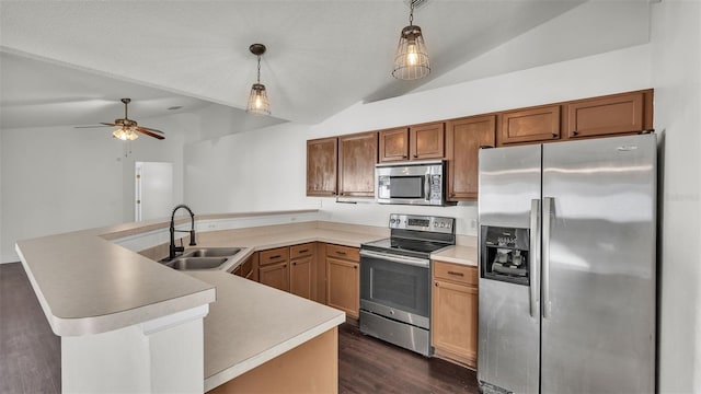 3917 NW Warbler Dr, Winter Haven, FL 33880 - kitchen with appliances with stainless steel finishes, lofted ceiling, a peninsula, dark wood-type flooring, and a ceiling fan