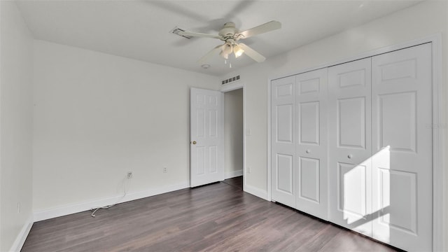 3917 NW Warbler Dr, Winter Haven, FL 33880 - unfurnished bedroom with dark wood-type flooring, a closet, and ceiling fan