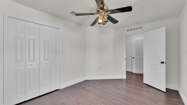 3917 NW Warbler Dr, Winter Haven, FL 33880 - unfurnished bedroom with wood finished floors, a closet, and ceiling fan