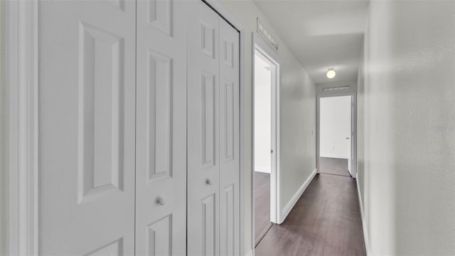 3917 NW Warbler Dr, Winter Haven, FL 33880 - corridor with dark wood-type flooring and baseboards