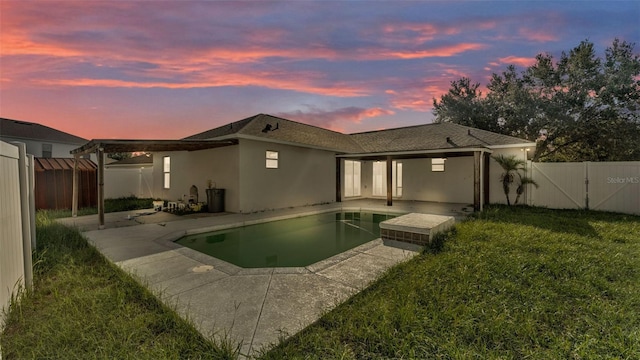 3917 NW Warbler Dr, Winter Haven, FL 33880 - rear view of property featuring stucco siding, a patio, and a fenced backyard