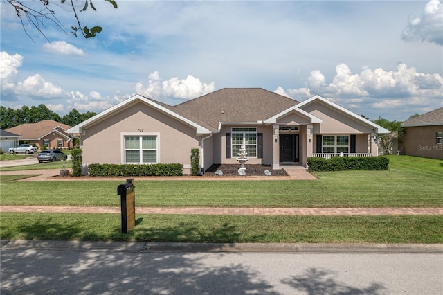 702 Country Walk Cv, Eagle Lake, FL 33839 - ranch-style home with stucco siding and a front yard