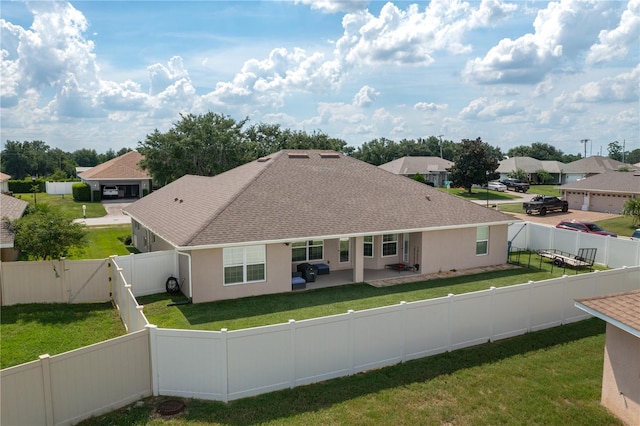 702 Country Walk Cv, Eagle Lake, FL 33839 - back of property with roof with shingles, a gate, a fenced backyard, a patio area, and a residential view