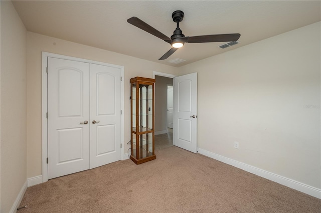 702 Country Walk Cv, Eagle Lake, FL 33839 - unfurnished bedroom with light colored carpet, a closet, and ceiling fan