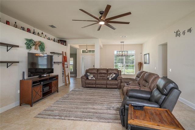 702 Country Walk Cv, Eagle Lake, FL 33839 - living room featuring a ceiling fan, light tile patterned floors, and a chandelier