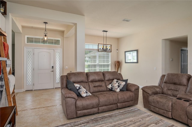 702 Country Walk Cv, Eagle Lake, FL 33839 - living room featuring light tile patterned floors and a chandelier