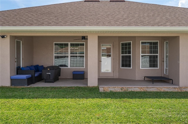 702 Country Walk Cv, Eagle Lake, FL 33839 - back of property with roof with shingles, a lawn, a patio area, stucco siding, and an outdoor hangout area