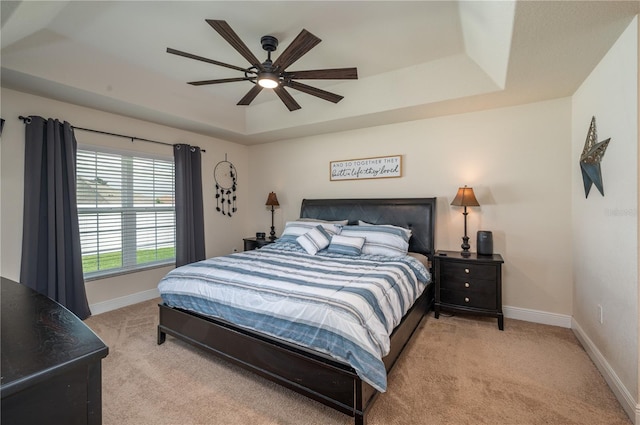 702 Country Walk Cv, Eagle Lake, FL 33839 - bedroom featuring a tray ceiling, carpet floors, and ceiling fan