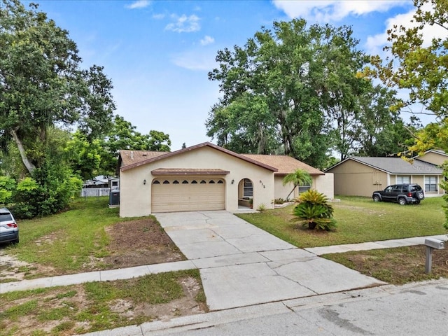 512 Hilldale Rd, Brandon, FL 33510 - view of front of house with a front yard, concrete driveway, stucco siding, and an attached garage