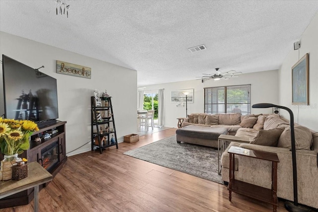 512 Hilldale Rd, Brandon, FL 33510 - living room featuring healthy amount of natural light, wood finished floors, a textured ceiling, and ceiling fan