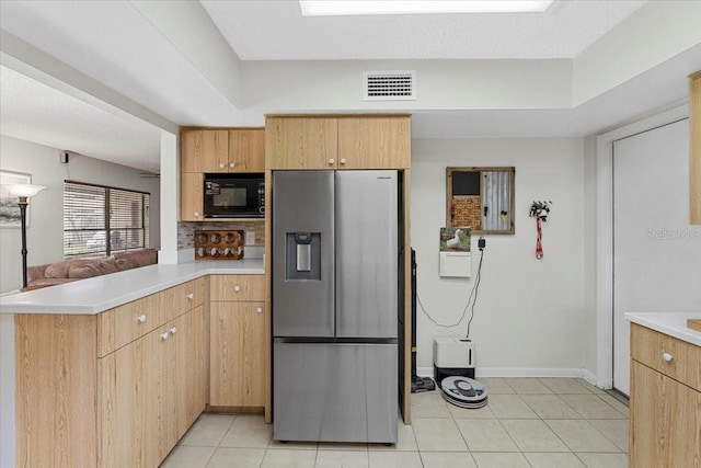 512 Hilldale Rd, Brandon, FL 33510 - kitchen with stainless steel fridge, black microwave, a peninsula, light countertops, and light tile patterned floors