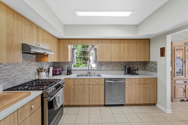 512 Hilldale Rd, Brandon, FL 33510 - kitchen featuring appliances with stainless steel finishes, under cabinet range hood, backsplash, light tile patterned floors, and light countertops