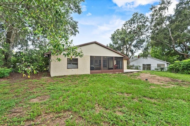 512 Hilldale Rd, Brandon, FL 33510 - rear view of property featuring a sunroom and stucco siding