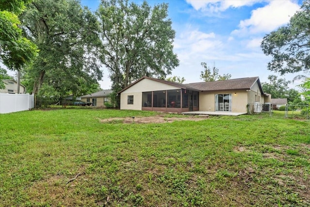 512 Hilldale Rd, Brandon, FL 33510 - rear view of house with a sunroom, a fenced backyard, stucco siding, and a patio area