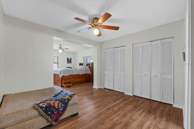 512 Hilldale Rd, Brandon, FL 33510 - bedroom with wood finished floors, two closets, ceiling fan, and a textured ceiling