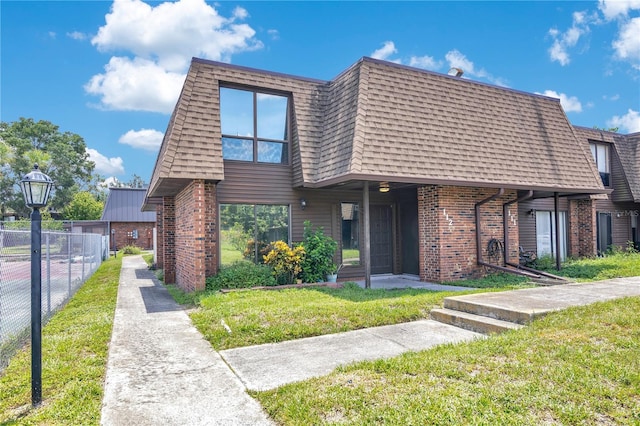 1836 N Crystal Lake Dr Unit 11, Lakeland, FL 33801 - view of front of property with brick siding, mansard roof, and roof with shingles