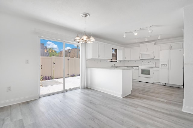 1836 N Crystal Lake Dr Unit 11, Lakeland, FL 33801 - kitchen with white appliances, a chandelier, white cabinets, light countertops, and light wood-style floors