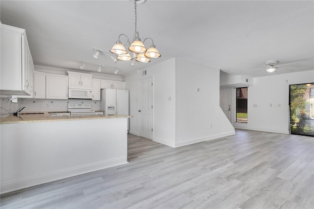 1836 N Crystal Lake Dr Unit 11, Lakeland, FL 33801 - kitchen with white appliances, a chandelier, open floor plan, decorative backsplash, and light wood-type flooring