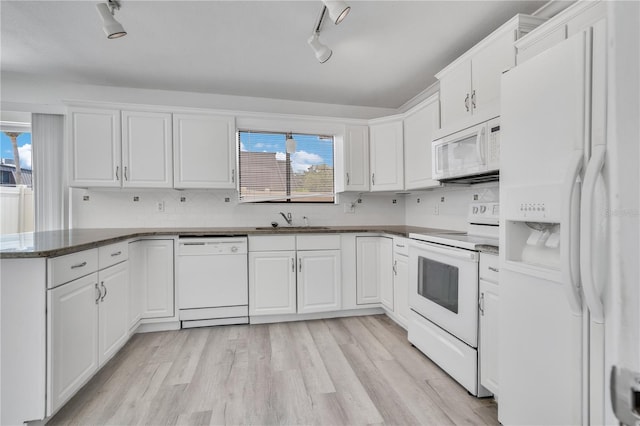 1836 N Crystal Lake Dr Unit 11, Lakeland, FL 33801 - kitchen with white appliances, white cabinets, rail lighting, light wood-type flooring, and a peninsula