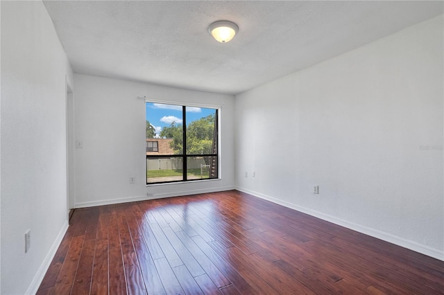1836 N Crystal Lake Dr Unit 11, Lakeland, FL 33801 - spare room featuring dark wood finished floors and baseboards