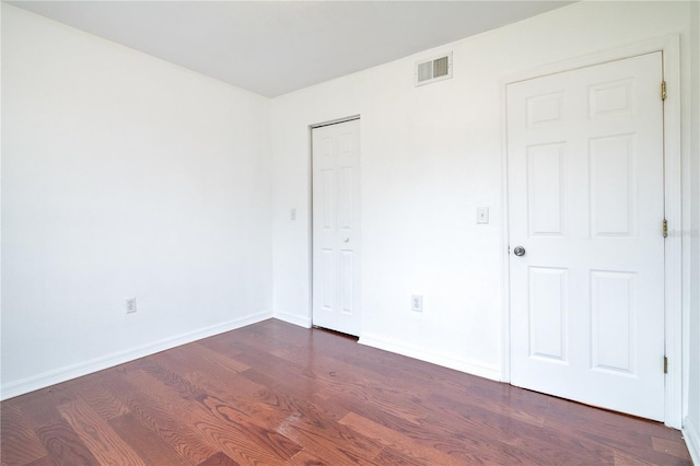 1836 N Crystal Lake Dr Unit 11, Lakeland, FL 33801 - unfurnished bedroom featuring wood finished floors and a closet