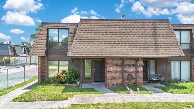 1836 N Crystal Lake Dr Unit 11, Lakeland, FL 33801 - view of front facade featuring brick siding and roof with shingles