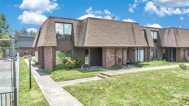 1836 N Crystal Lake Dr Unit 11, Lakeland, FL 33801 - view of front property with brick siding, mansard roof, and a shingled roof