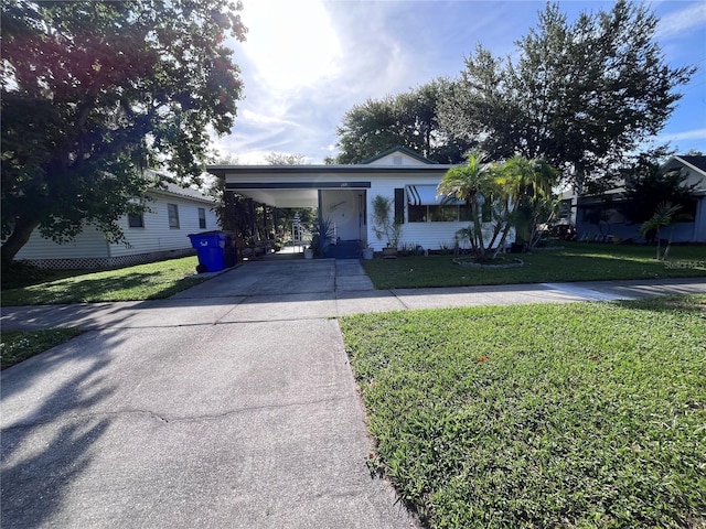 1319 Florida Ave, Saint Cloud, FL 34769 - view of front of property featuring driveway, an attached carport, and a front lawn