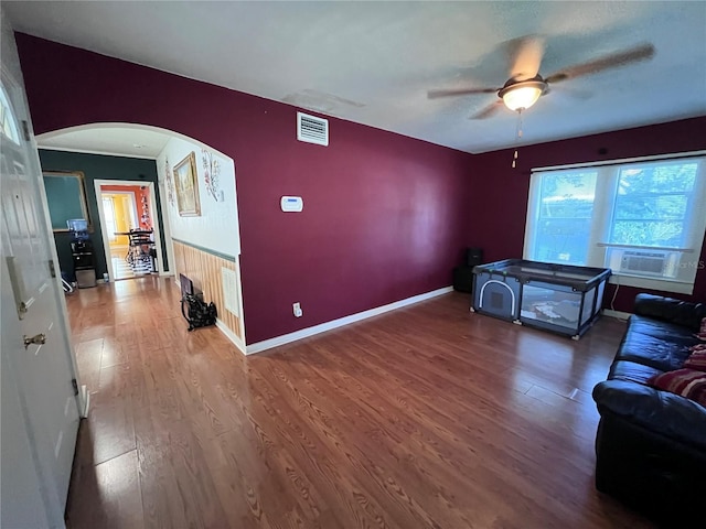 1319 Florida Ave, Saint Cloud, FL 34769 - living room with arched walkways, a ceiling fan, and wood finished floors
