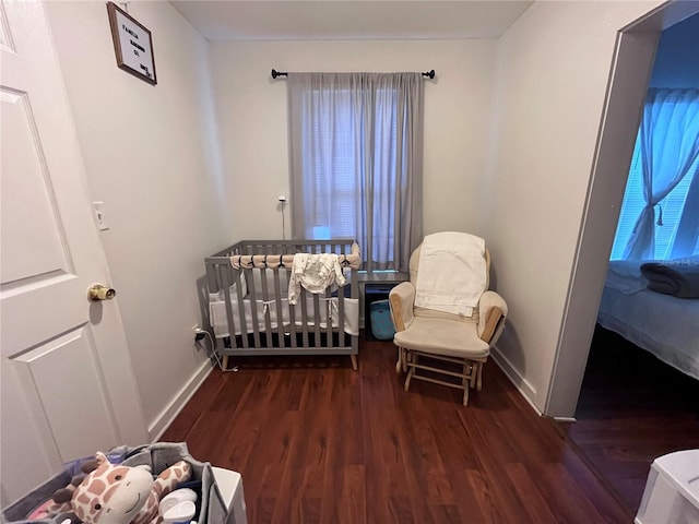 1319 Florida Ave, Saint Cloud, FL 34769 - bedroom featuring wood finished floors and a nursery area