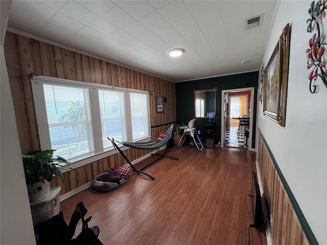 1319 Florida Ave, Saint Cloud, FL 34769 - workout room featuring ornamental molding, wood finished floors, and wooden walls