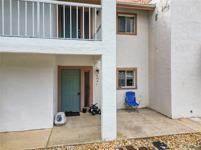 404 Country Ln NE Unit 404, Winter Haven, FL 33881 - doorway to property with stucco siding