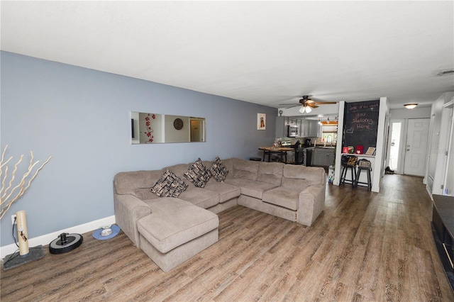 404 Country Ln NE Unit 404, Winter Haven, FL 33881 - living area featuring a ceiling fan and wood finished floors