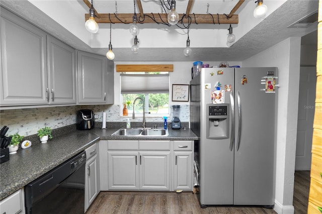 404 Country Ln NE Unit 404, Winter Haven, FL 33881 - kitchen featuring stainless steel fridge, black dishwasher, dark countertops, and wood finished floors