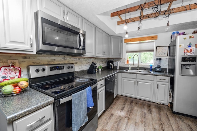 404 Country Ln NE Unit 404, Winter Haven, FL 33881 - kitchen with appliances with stainless steel finishes, a tray ceiling, dark countertops, and tasteful backsplash