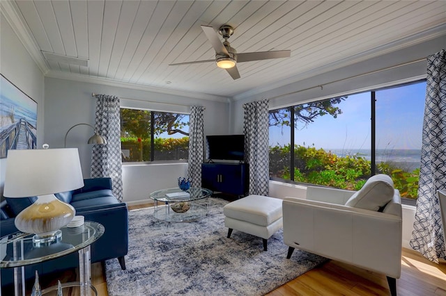 living room featuring wood ceiling, light hardwood / wood-style floors, ceiling fan, and a healthy amount of sunlight