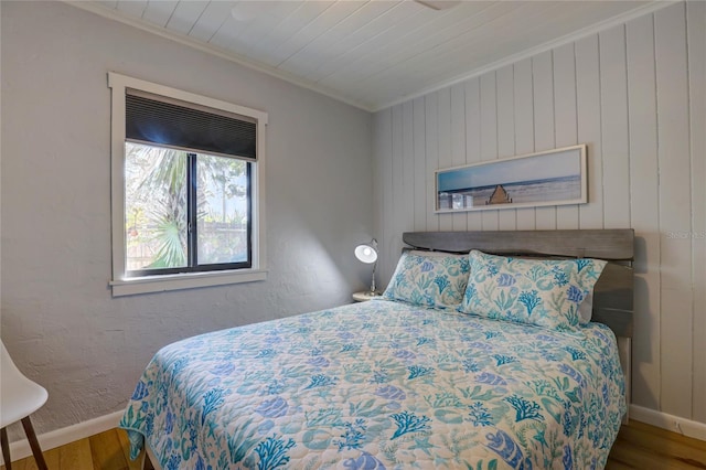 bedroom featuring crown molding and wood-type flooring