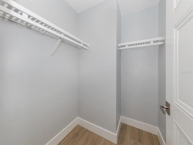 spacious closet featuring hardwood / wood-style floors