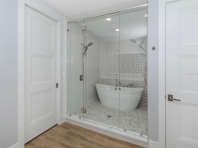 bathroom featuring separate shower and tub