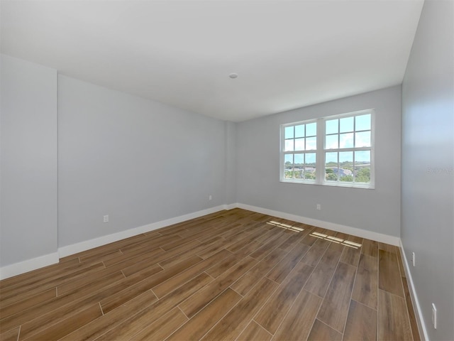 spare room with wood-type flooring