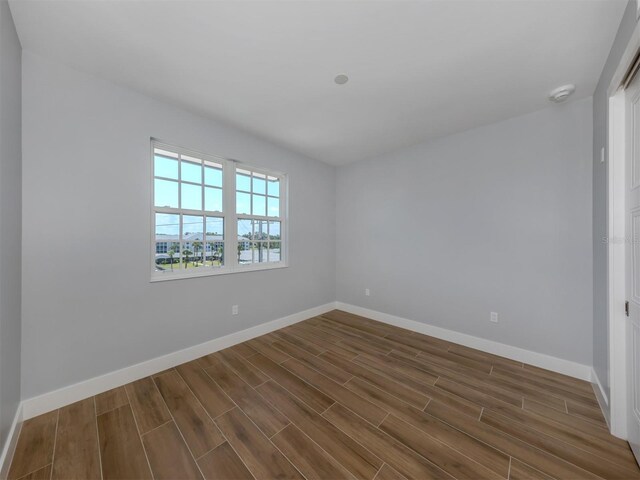 spare room with dark hardwood / wood-style flooring