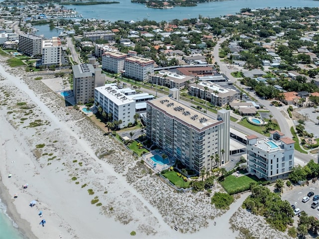 aerial view with a water view and a beach view