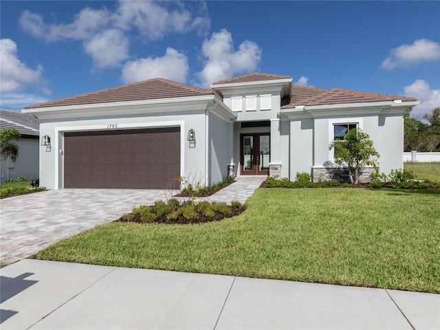 view of front of property with a garage and a front lawn