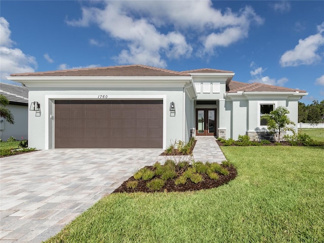 view of front of property with a garage and a front lawn